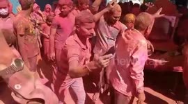 Locals take part in traditional stick dance during Holi celebrations in India