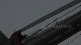 BLM protester climbs crane in London's Canning Town