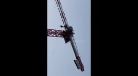 Protester climbs tower crane east London