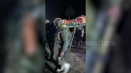 Army personnel carry pregnant woman on shoulders in northern India