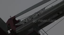 Protester climbs crane in London's Canning Town to hang Black Lives Matter sign