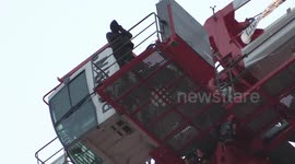 London protestor scales crane, unfurls 'dads' lives matter just as much as mums' banner
