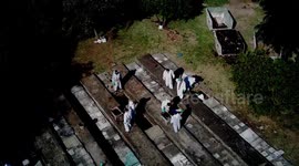 Aerial of Sao Paulo cemetery workers clearing bodies for arrival of new Covid dead