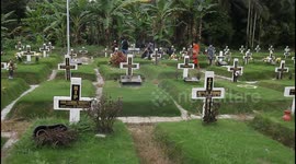 Indonesian Christians tend to family graves in Medan on Good Friday