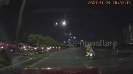Brave policeman clings to motorcycle after drivers tried to escape traffic control