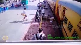 Security personnel rescue elderly man who was about to get crushed under a moving train in Northern India.