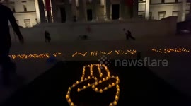 Myanmar activist creates three-fingered  'Hunger Games' salute with a candlelit vigil outside National Gallery in London