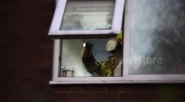 Firefighter investigating the cause of fire at Jenkins Street flat, Small Heath, Birmingham 03/04/2021
