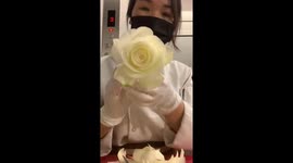 Vietnamese woman intricately sculpts beautiful rose out of papaya