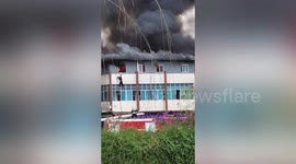 Chinese man jumps from second-floor window to escape burning building