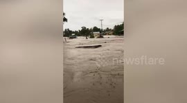 Residents wade through floodwater after Tropical Cyclone Seroja hits Indonesia