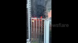 Smoke billows as fire engulfs high-rise roof in Manila