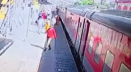 Security personnel rescue woman trapped between train and platform in northern India