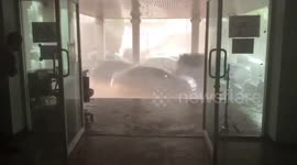 Residents shelter in building as tropical summer storms hit northern Thailand