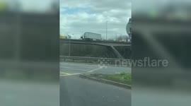 This video shows the aftermath of a crash on the M25 today (Weds) that left a lorry hanging off a motorway bridge