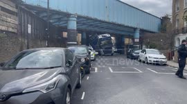 Large truck gets stuck under a bridge in Camden, north London