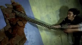 Animal rescuers catch 10-foot python stuck in gap between walls