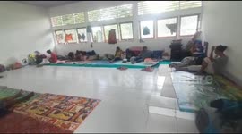 Displaced residents take shelter in village hall after Tropical Cyclone Seroja strikes Indonesia