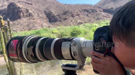 A 7-year-old boy learns photography by shooting a high-end professional Canon camera in bursts, he uses a 1dxMark II and a 500mm canon long lens to photograph nature. The child has fun in a country house next to the river and forest in Soyopa Mexico, whil