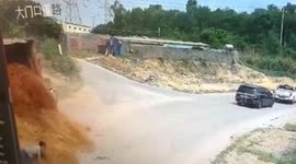 Chinese pedestrian narrowly escapes being buried after truck transporting mud crashes