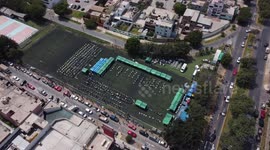 Aerial footage of the Malvinas sports field in Santiago de Surco, Peru on vaccination day