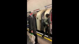 Piers Corbyn being escorted onto the tube by police at anti-lockdown protest