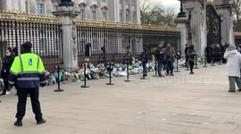 People lay flowers at the gates of Buckingham Palace following Prince Philip’s death