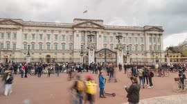 panning timelapse of mourners, press, police and passersby at Buckingham Palace on the day of Prince Philip's passing