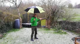 A sudden snow shower interrupts a socially distanced cup of tea in the garden