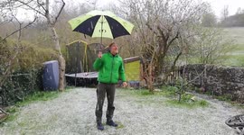 Sudden snow shower interrupts socially distanced cup of tea in English garden