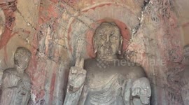 Buddhist statue displays V-sign due to weathering in central China