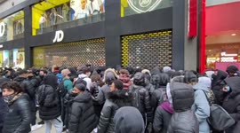 Long queues form outside London shops as lockdown eases in England