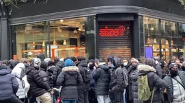 Large crowd gathers outside shoe shop on Carnaby St in London as stores prepare to reopen