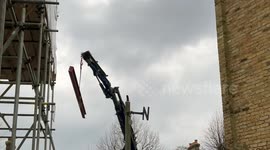750kg steel beam bounced off scaffolding and spun 180 degrees in mid-air to fit through narrow gap between houses