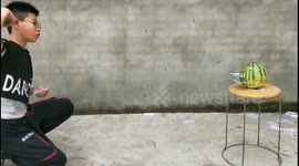 Chinese boy is able to slice fruit in two by flinging playing cards