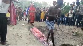 Devotees walk barefoot across burning embers during religious tradition in India