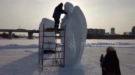 Russian artist sculpts huge angel figures out of snow