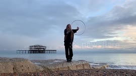 Hula hoop artist breaks the laws of physics on the beach