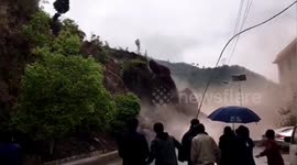 Locals watch on as rocks and mud crash down mountain in southern China