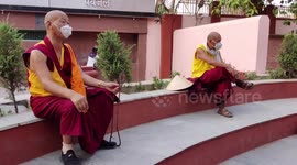 Buddhist monks praying outside pandemic closed Mahabodhi temple in Bodh Gaya, Bihar, India