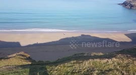 Jogger Exercising on the beach after lockdown  Holywell bay North Cornwall