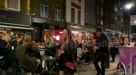 Londoners swarm Soho for Friday night revelry following lockdown lift