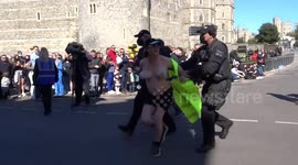 Closeup footage shows topless protester being taken away by police outside Prince Philip’s funeral