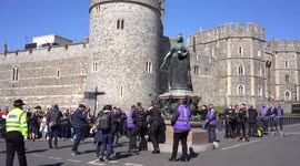 Topless protester shouts 'save the planet' near Windsor Castle during Prince Philip's funeral