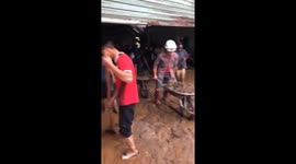 Teams work to clear debris after deadly flash flood buries Vietnamese village in mud