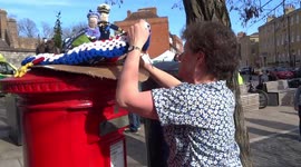 Artist is packing her Ickenham Posbox Topper tapestry to give it as a gift to the queen