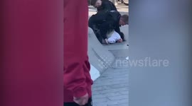 A man holding a knife gets tasered by police surrounded by members of the public