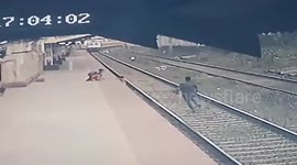 Dramatic moment heroic Indian railway worker risks life to save child from being crushed under train