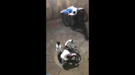 The men riding the motorbikes move in circles and climb up in the iron cages