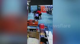 Supermarket employee rushes to save elderly man in wheelchair rolling down escalator